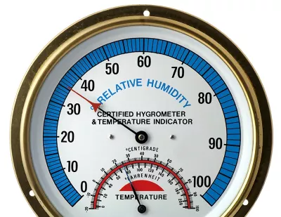 A thermometer gauge that also measures relative humidity on a blue scale in Centigrade and Fahrenheit.