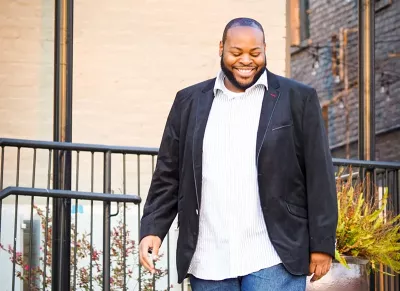 Terrance Bonner in a black jacket walking down the street.