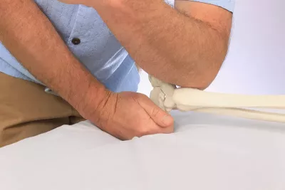 a practitioner working on a client's foot and ankle joints and talus.