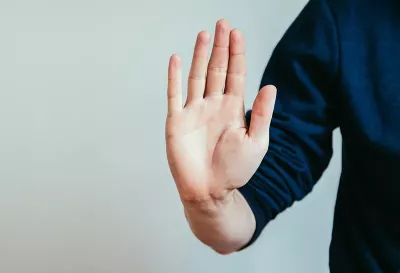 a hand raised up, making a stop gesture. 