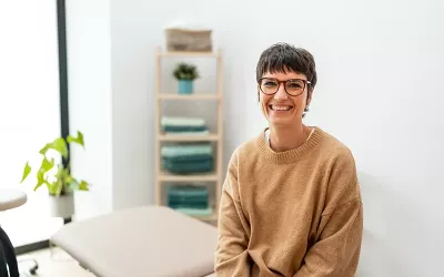 A massage therapist smiles for a photo.
