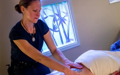 Picture of Julie Platcha massaging a client.