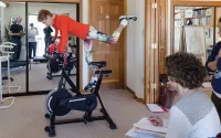 Judith Aston on an exercise bike instructing