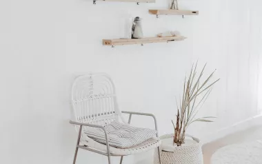 an empty waiting room with one chair and some wooden shelves. 