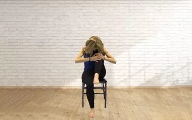 Author Angie Parris sits in a chair, taking a deep breath.