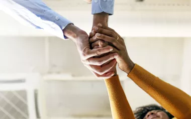 two people clasping their hands together.