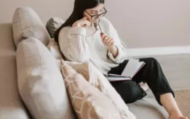 an adult looking over notes thinking about what they are reading.