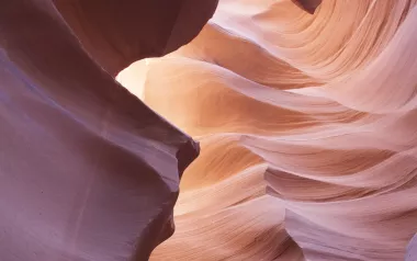 Pink and red canyon rock formations that demonstrate flow. 