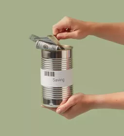 Two hands holding and opening a silver can with a dollar inside.