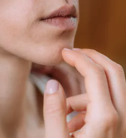 Female tapping her chin with her fingers.