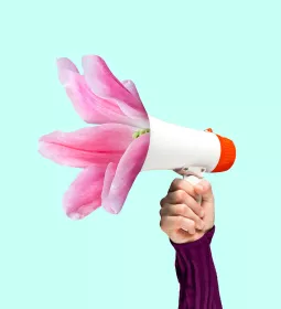 Upraised human arm holding bullhorn.