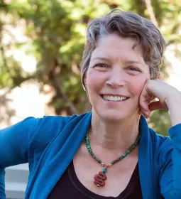 Dr. Betty Martin smiling with her hand to her face.