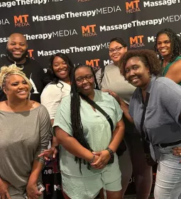 Attendees at the inaugural Black Massage Therapist Conference smile for a photo.