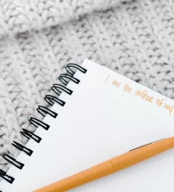 a blank notebook page with the words written &quot;I am the author of my own story.&quot;