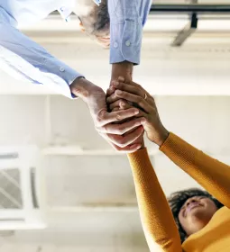 two people clasping their hands together.