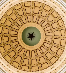 gold adorned dome ceiling of a court or government building.