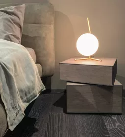 a tranquil room with a bed and globe-shaped floating lamp giving off soft light.