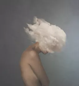 a nude person with their head literally in a cloud.