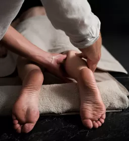 A massage therapist massaging a clients' leg.