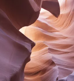 Pink and red canyon rock formations that demonstrate flow.