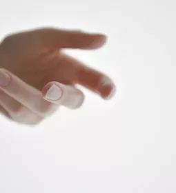 a person's hand reaching outward.