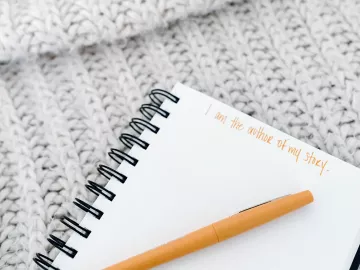 a blank notebook page with the words written "I am the author of my own story."