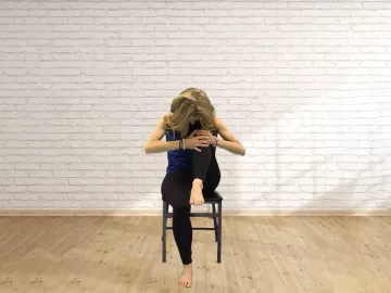 Author Angie Parris sits in a chair, taking a deep breath.