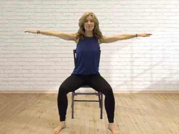 LMT Angie Parris sits in a chair and takes in a deep breath.