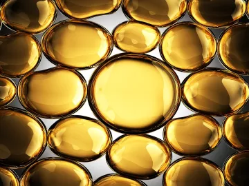 Futuristic, shiny gold globules filled with an oily substance.