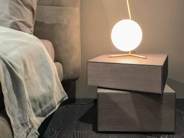 a tranquil room with a bed and globe-shaped floating lamp giving off soft light.