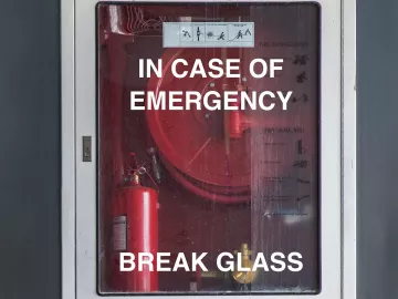 A glass fire case reads "in case of emergency break glass".