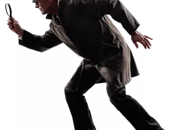 Detective in a coat and hat with a magnifying glass tiptoeing.
