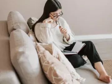 an adult looking over notes thinking about what they are reading.