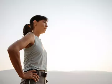 Woman outside taking deep breaths. 