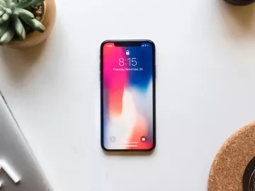 A mobile phone rests on a table.