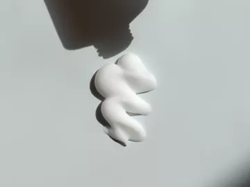 Cream comes out of a tube.