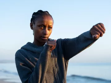 A woman throws a punch.