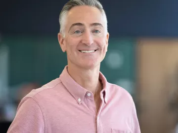 Portrait image of Darren Buford in a pink button-down shirt.