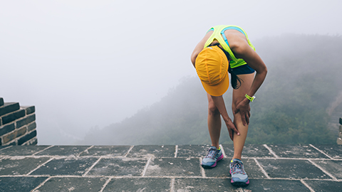 Image of a person holding their shin.