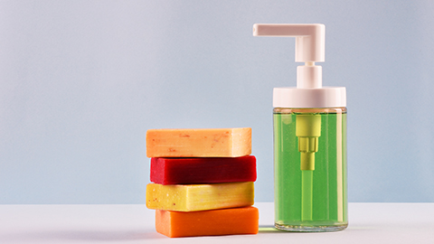 Soap dispenser and multi colored soap bars.