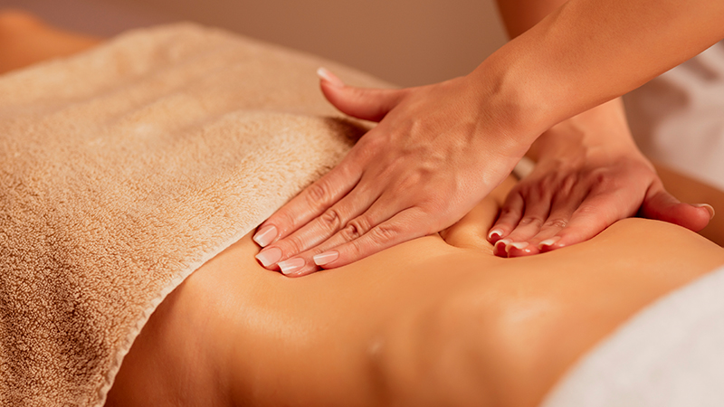 Woman enjoying in relaxing massaging at health spa treatment.