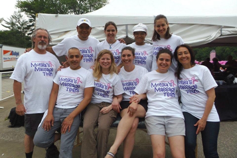 A group of people wearing the same pattern of T-shirts pose for a photo.